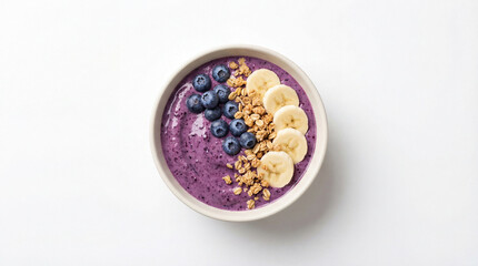 Healthy blueberry smoothie bowl topped with fresh berries, banana slices, and granola