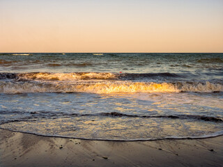 Strong sea waves rolling on sandy beach at Black Sea coast © Dan Badiu
