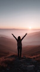 Fototapeta premium silhouette of a happy woman with hands up on the top of the mountain in sunset light