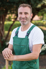 Naklejka premium smiling man gardener standing outdoors