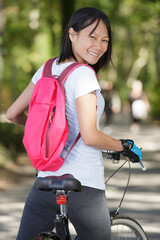 Fototapeta premium young lady stood astride her bicycle