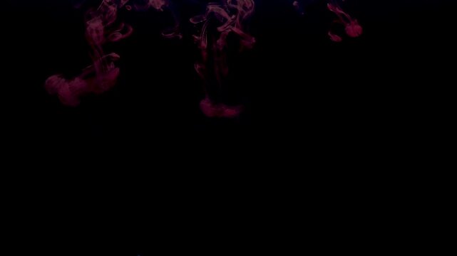 Abstract pink smoke flows through dark space like a magic fireball in motion against a black night sky with bright light flashes