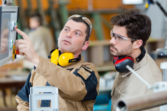 industrial supervisor setting the machine
