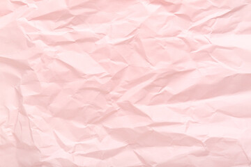 Fototapeta premium Pink crumpled sheet of paper as background, top view