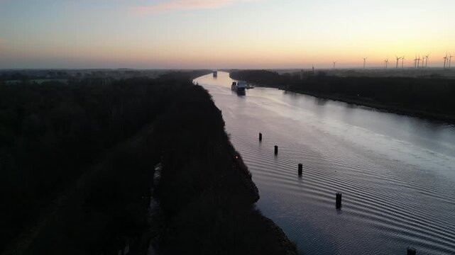 Schiffe fahren bei Sonnenaufgang durch den Nord-Ostsee-Kanal