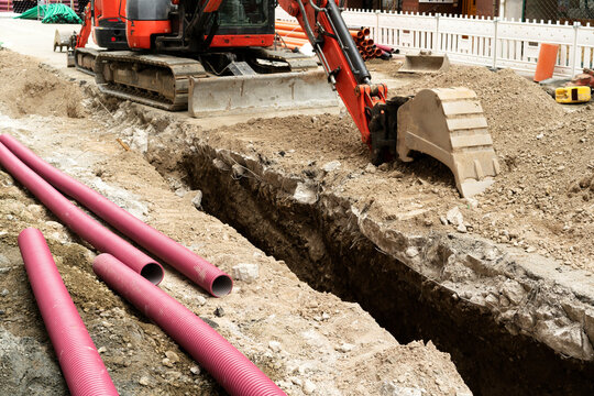 construction workers repairing old pipes of sanitation, water and internet networks on street city