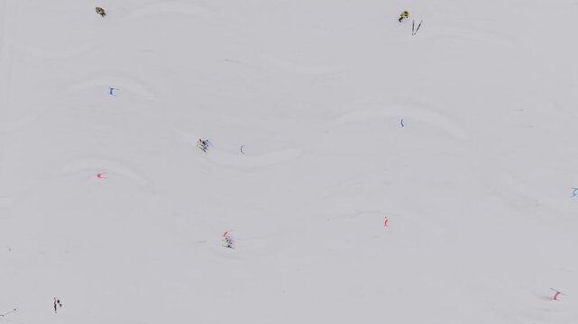 Aerial top view of parallel slalom ski race with two athletes racing down snowy slope