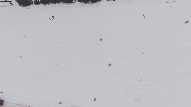 Aerial top view of parallel slalom ski race with two athletes racing down snowy slope
