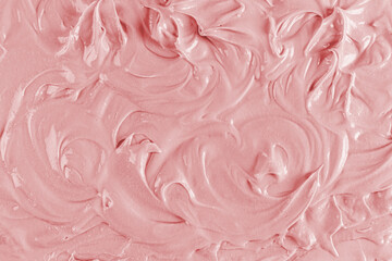 Obraz premium Delicate swirl curls of the texture of creamy fruit cream. pink texture with a pattern. A sample of the pink berry texture cream. selective focus