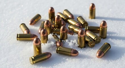 Shiny brass pistol cartridges with copper tips scattered across a pristine white snow surface