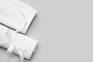 Composition with clean soft towels on grey background, closeup