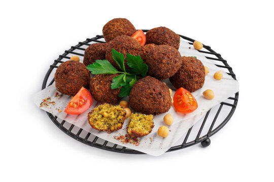 Stand with delicious falafel balls, chickpea and tomato on white background
