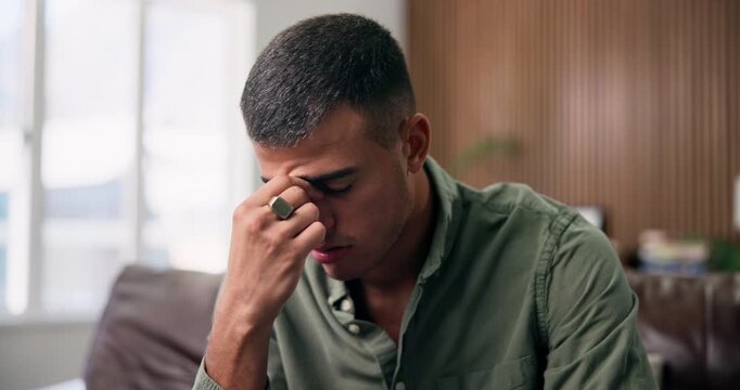 Frustrated, man and headache with stress in home for mental health, depression or anxiety. Tired, male person or mistake with migraine or fatigue for burnout, regret or crisis on sofa in house