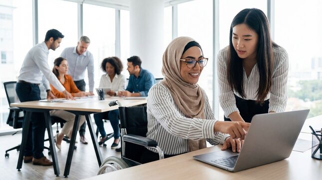 Two diverse businesswomen collaborating on a laptop in a modern multicultural office.