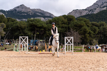 Obraz premium Horse riding - portrait of lovely equestrian on a white horse