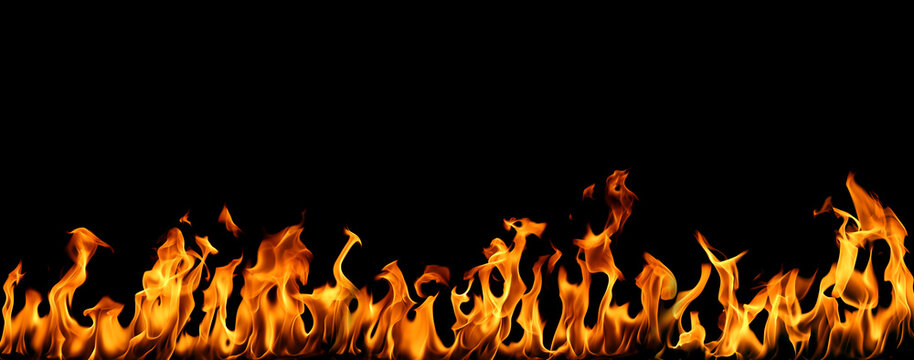 Bright orange fire flames burning in a horizontal line isolated on black background, realistic heat energy blaze with dynamic flame shapes and glowing light. Abstract fire border for danger, power.