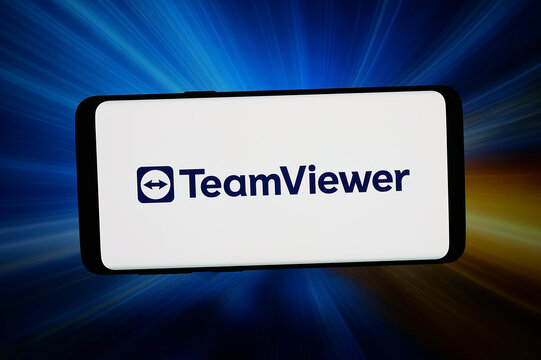 Stuttgart, Germany - 03-09-2026: In this photo illustration, the logo of remote access software company TeamViewer SE is displayed on a smartphone in front of abstract background on computer screen.