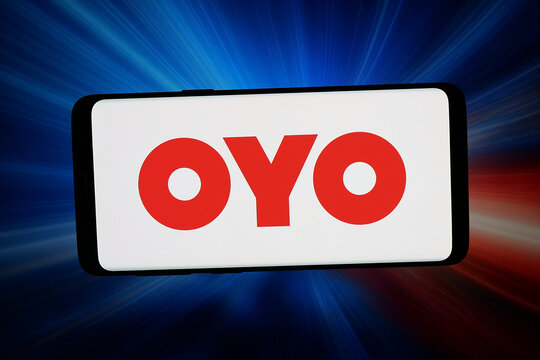 Stuttgart, Germany - 03-09-2026: In this photo illustration, the logo of Indian hospitality company OYO Rooms is displayed on a smartphone in front of abstract background on computer screen.