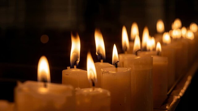 Row of pillar candles burning, flames lengthening and wax melting, creating interior design scene