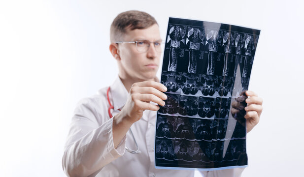 Caucasian male doctor examining x-ray image for medical analysis