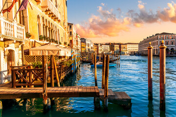 romantic view of a canal in Venice with boats and blue water and beautiful vintage buildings around the cityscape © Yaroslav