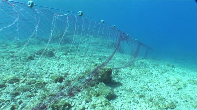 old fish net underwater ghost hunting pollution of oceans by driftnets