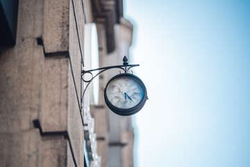 Round vintage outdoor clock on a stone building