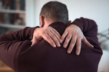 Obraz premium Man with neck, muscle, back and sciatica pain at home.