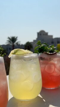 Assortment of five colorful tropical cocktails at a luxury resort in Egypt. Variety of refreshing summer drinks with exotic garnish on a sunny poolside terrace.
