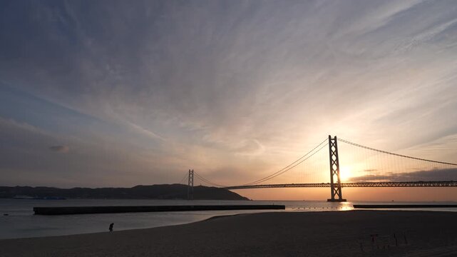 Akashi Kaikyo Bridge at sunset in Kobe Japan with ocean view