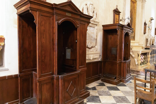 Wooden confession booths inside catholic church interior.