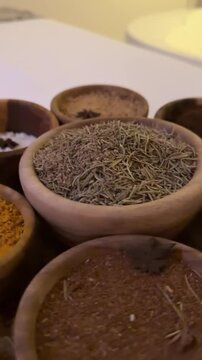 Traditional Egyptian spices in handcrafted clay bowls. Aromatic variety of Middle Eastern herbs and seeds at a local market, celebrating rich Arabic culinary culture and textures.