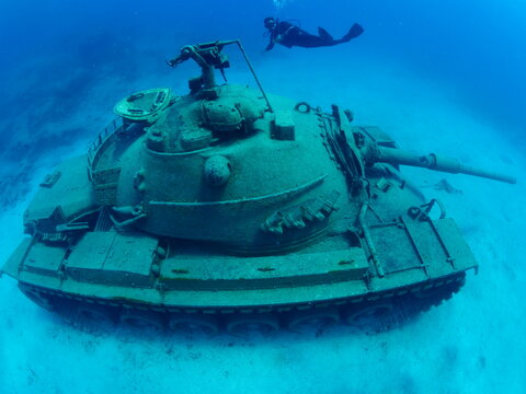 tank wreck underwater armed gun ocean scenery metal on sea floor scuba divers to explore