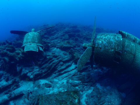 scuba divers exploring airplane wreck underwater  c47 Dakota aircraft 