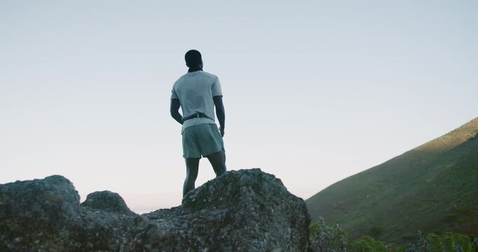 Hiking, celebration and black man with view, fitness for challenge and milestone for goals, ocean and pride. Nature, seaside and person with mountain, climbing and arms up for training and trekking