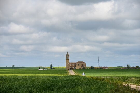 Santa Maria Arbis Church in Baquerin de Campos with road leading to entrance
