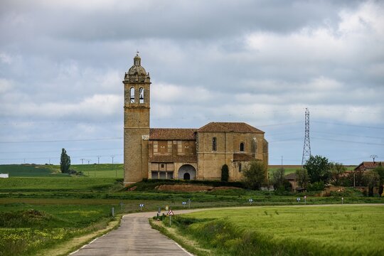 Santa Maria Arbis Church in Baquerin de Campos with road leading to entrance