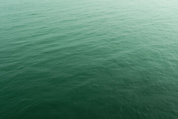 Obraz premium Serene Green Ocean Water Surface with Gentle Ripples and Subtle Gradient Perfect for Backgrounds or Calming Visual Effects