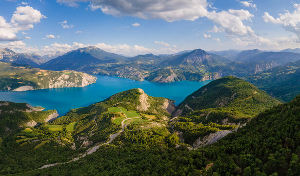 Aerial view of turquoise water of Lake Serre-Poncon in the French Alps. Summer in mountains and forests of Hautes-Alpes, France