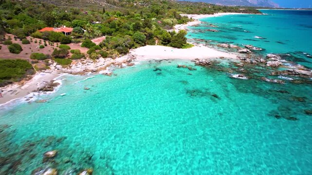Sardegna Tropics of Europe, Italy. Sant Elmo aerial flight over granite rocks and white sand beach turquoise water Italy drone 4k cinematic rugged coastline scenery