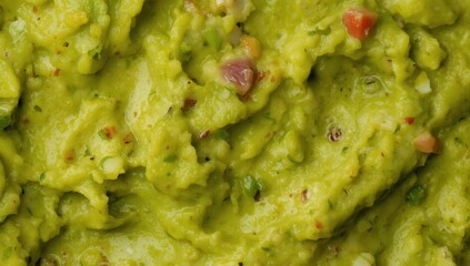Close-up of smooth guacamole on a solid background