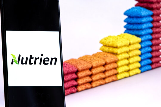 Nutrien company logo displayed against a background of fertilizer bags. Nutrien is an American producer and marketer of crop nutrients and fertilizers.