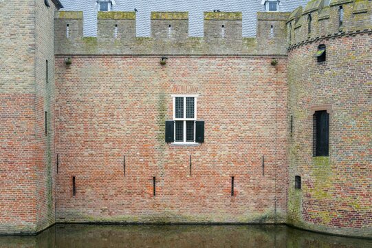 Radboud castle brick wall reflecting in moat water
