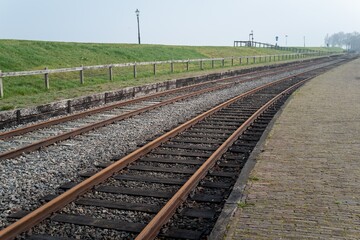 Parallel railway tracks running along a dutch dike in medemblik