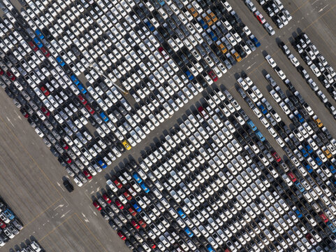 Aerial view of a vast expanse of neatly aligned cars in a monochrome symphony broken by vibrant pops of color, Shanghai, Shanghai, China.