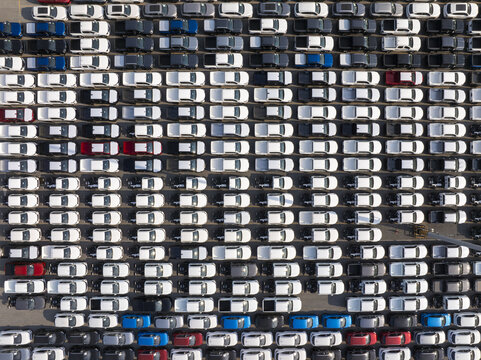 Aerial view of orderly rows of parked cars, a symphony of whites, grays, and blues create a mesmerizing geometric pattern, Shanghai, Shanghai, China.