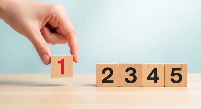 A person hand placing a wooden block with the number one next to a sequence of numbers on a table