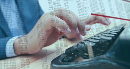 Typing blue-suited man entering codes on keyboard at wood desk showing phone keypad numeric overlay