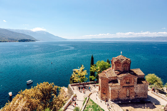 View of the serene Church of St. John at Kaneo standing majestically on the cliffside overlooking the tranquil blue waters, Ohrid, Municipality of Ohrid, North Macedonia.