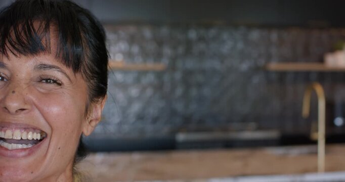African American woman entering frame, facing camera, laughing, smiling in kitchen sink, copy space